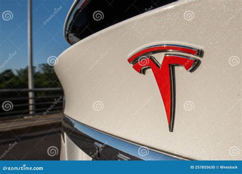 Closeup Of A Red Tesla Logo On A White Car Editorial Image Image Of