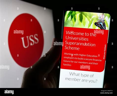 Person Holding Smartphone With Website Of Universities Superannuation