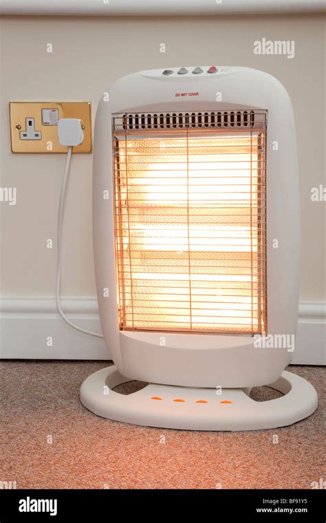 Electric Halogen Room Heater With Three Heat Settings Plugged Into