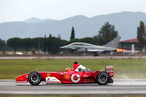 Michael Schumacher in his Ferrari F2003 GA, competing against an ...