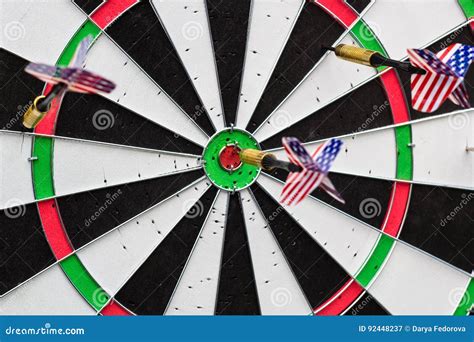 Dart Arrow Hitting In The Target Center Of Dartboard Stock Image