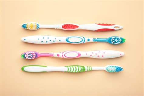 Premium Photo Toothbrushes On Beige Isolated