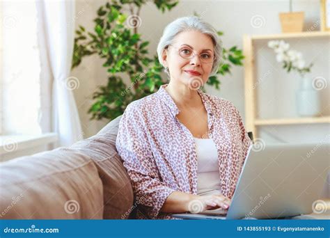 Happy Old Woman Senior Working At Computer Laptop At Home Stock Image