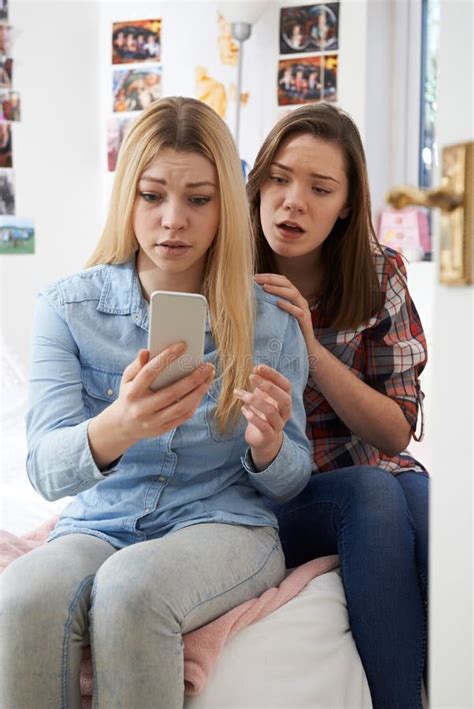 Tiener Die Ongelukkige Vriend In Slaapkamer Troosten Stock Foto