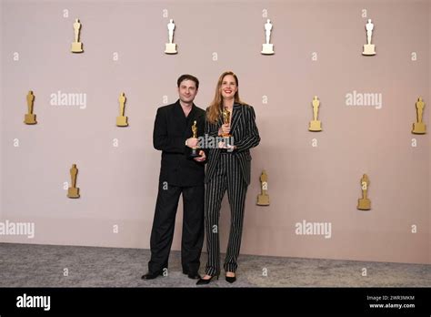 Arthur Harari Left And Justine Triet Pose With The Award For Best