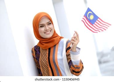 Muslim Woman Happy Holding Malaysian Flag Stock Photo