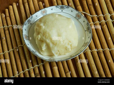 Fufu Mixing And Pounding Separate Equal Portions Of Cassava And Green