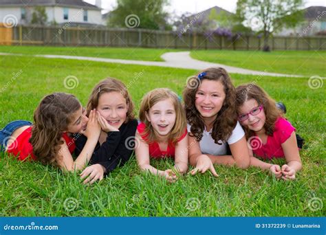 Children Girls Group Lying On Lawn Grass Smiling Happy Stock Image