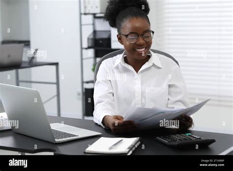 Professional accountant working at desk in office Stock Photo - Alamy