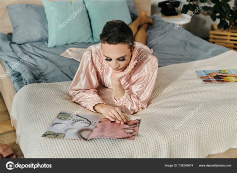 Stunning Drag Queen Lounges Bed Engrossed Magazine Stock Photo