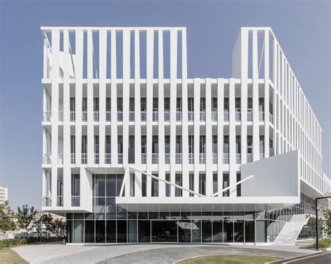 A Large White Building Sitting On The Side Of A Road