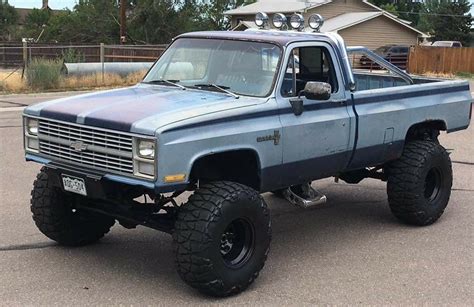 A Blue Pick Up Truck Parked In A Parking Lot