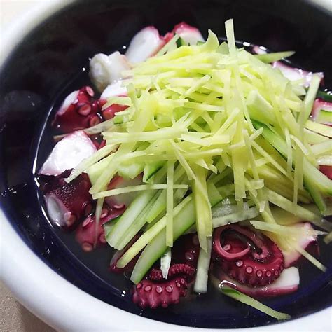 A Bowl Filled With Sliced Up Vegetables On Top Of A Table