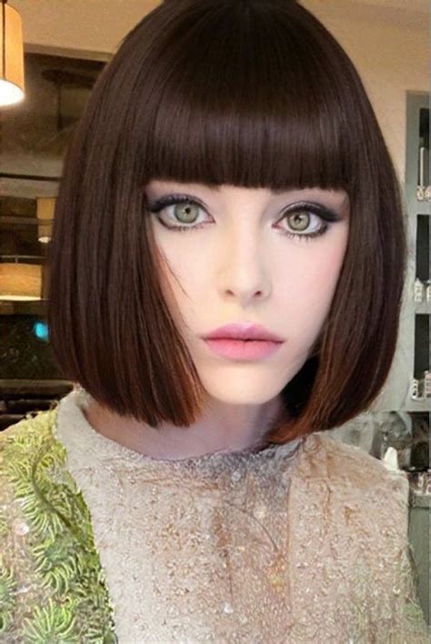 A Close Up Of A Mannequin Wearing A Short Bob Haircut With Bangs