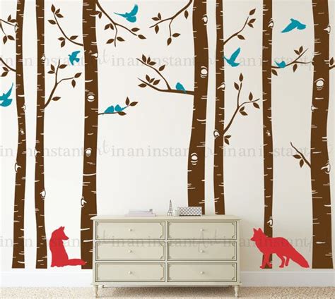 The Wall Decals In This Room Are Painted With Red And Blue Trees Birds