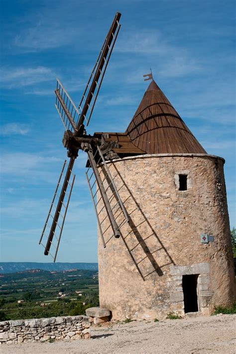 An Old Stone Windmill On Top Of A Hill