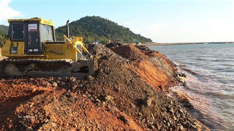 The Sea Construction Stronger Bulldozer Dump Truck Spreading Dirt