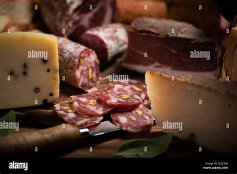 Cutting Board With Ham Salami Cheese Bread On A Rustic Wooden Board