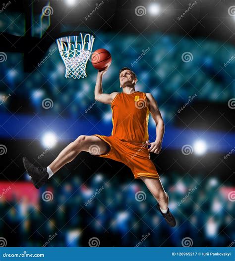 Basketball Player Making Slam Dunk On Basketball Arena Stock Image