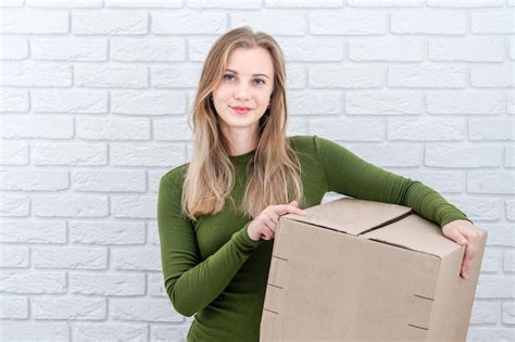 Premium Photo Attractive Woman Holding Parcel Box Delivering A Parcel