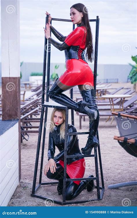 Dominant Woman With Her Slavegirl Outdoor Shows Exhibitionism Stock