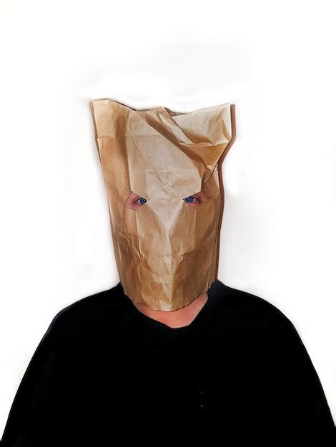 Premium Photo Portrait Of Man Wearing Brown Paper Mask Against White