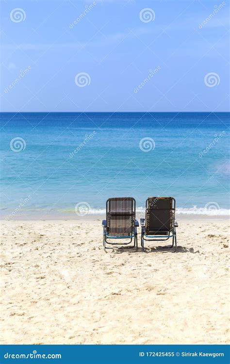 Beach Chair On White Sand Over Blue Sea And Clear Blue Sky Stock Image