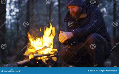 Man Warms Himself At Camp Fire In The Forest Stock Image Image Of