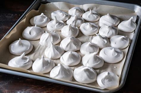 Tray Of Meringues Dusted With Confectioners Sugar And Ready To Be