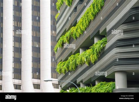 Modern Skyscraper Wall With Green Plants Terraces In Singapore City