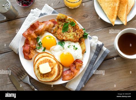 Full American Breakfast On Wooden Top View Sunny Side Fried Eggs