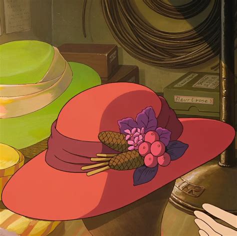 A Pink Hat Sitting On Top Of A Table Next To Plates And Other Items In