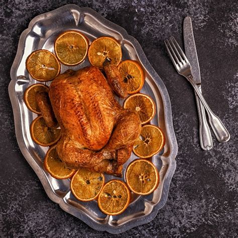 Pollo Entero Asado Con Rodajas De Naranja Foto Premium