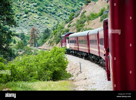 Mountain train makes its way through the mountains Stock Photo - Alamy