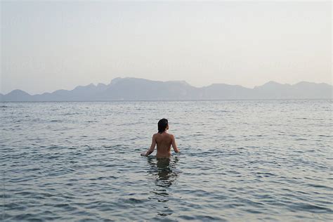 Woman Swimming Naked In The Sea On A Summer Morning By Stocksy