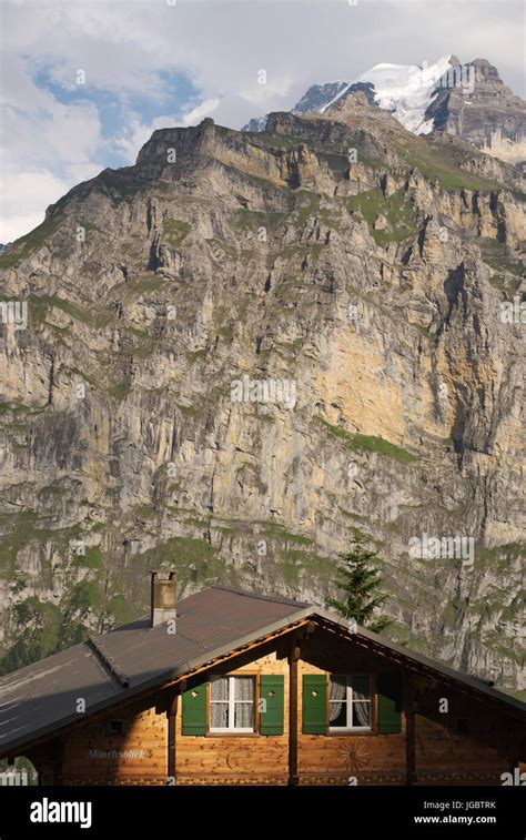 a mountain chalet and the Monch glacier in the background, Murren ...