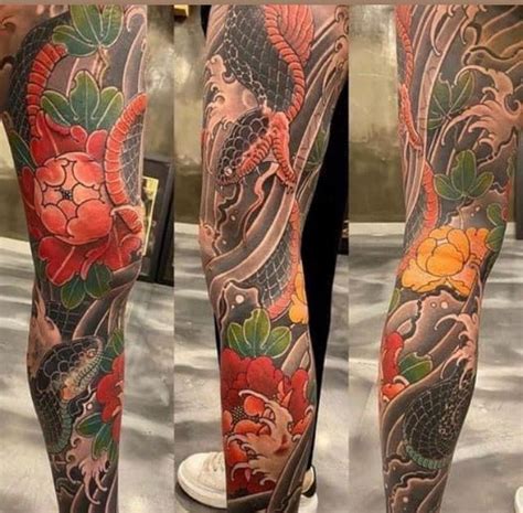 The Legs Are Covered With Tattoos And Flowers