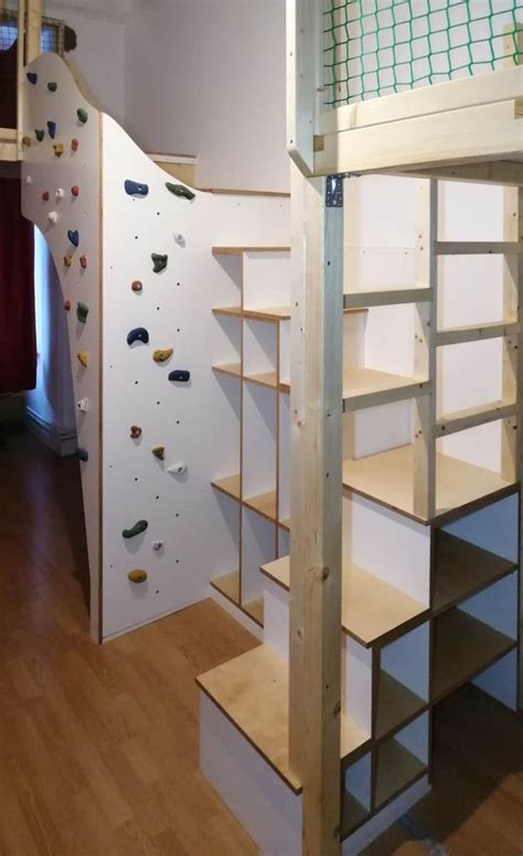 There Is A Climbing Wall In The Room With Stairs And Ladders To Climb Up