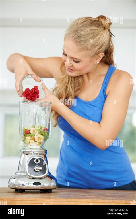 Getting Ready To Blend The Perfect Smoothie Attractive Young Woman Making A Fruit Smoothie