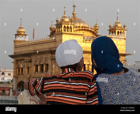 Sikh Pilgrims Resting In Front Of The Golden Temple After A Long