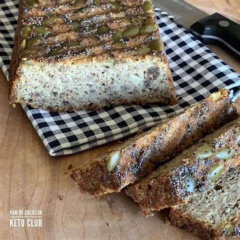 Sliced Loaf Of Bread Sitting On Top Of A Wooden Cutting Board Next To A