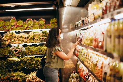 Woman Browsing through Groceries on a Shelf in a SupermarketFree