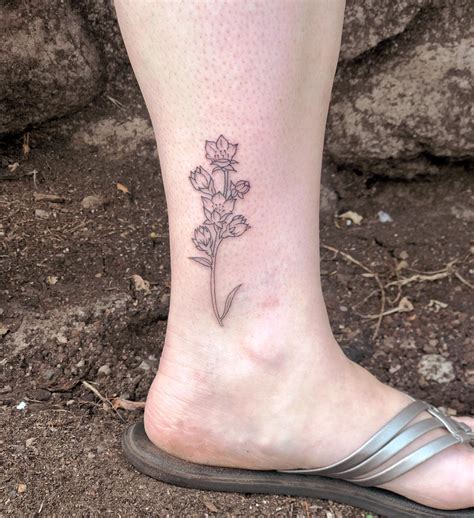 Larkspur Tattoo Ideas for Delicate Beauty and Spiritual Significance