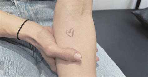 Tiny Minimalistic Heart Tattoo Located On The Inner