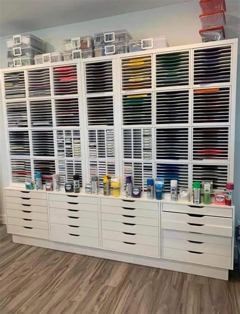 A Large White Cabinet Filled With Lots Of Drawers