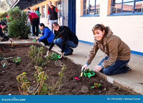 Diverse People Performing Community Service Gardening At Local Township