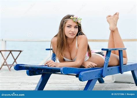 Young Beautiful Woman Enjoying Sunny Day On Sun Lounge Royalty Free