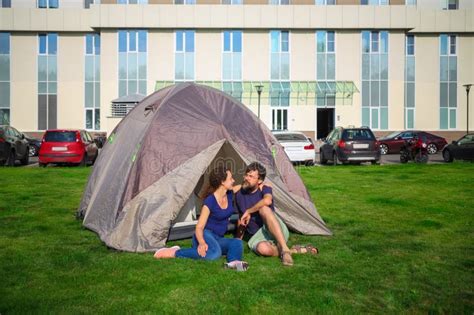 Happy Woman And Man Sit On Grass Near Tent Near Stock Photo Image Of