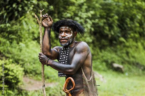 Portrait Of Dani Tribe Man Wearing Koteka Traditional Clothes Of Papua