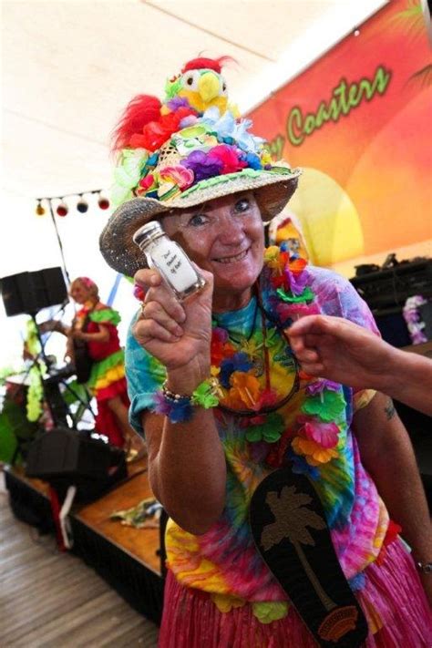 A Woman Wearing A Colorful Hat And Holding A Cell Phone